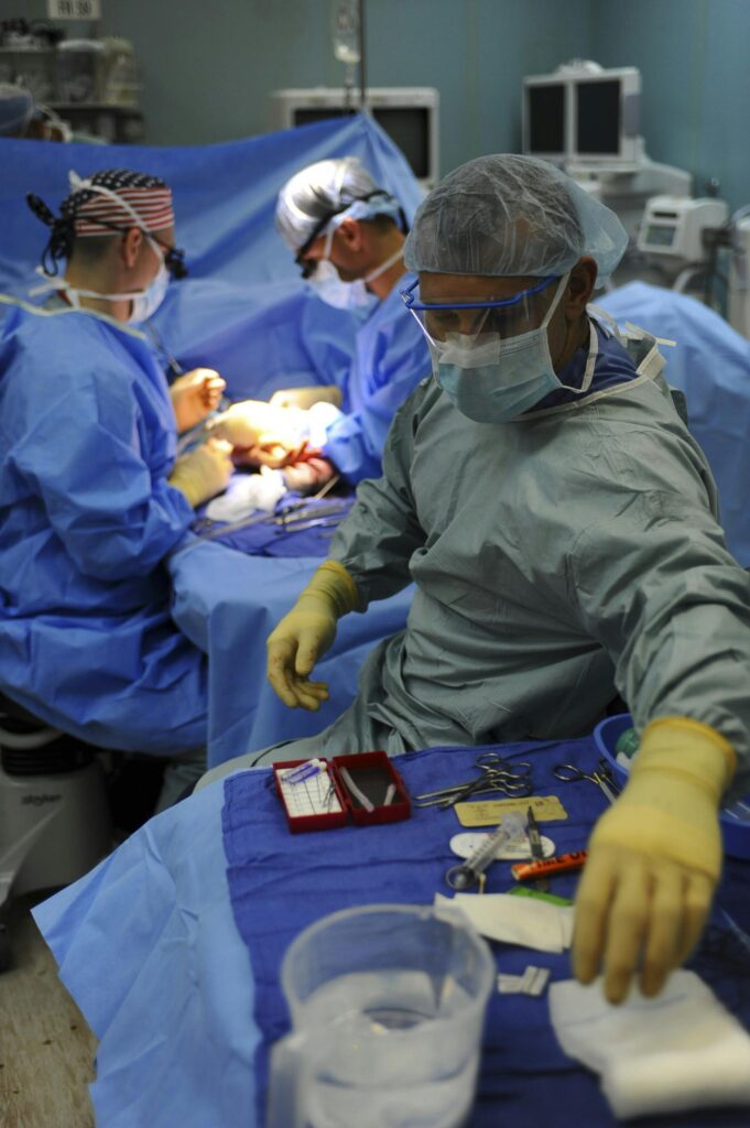 pexels-photo-263337-263337 Team of surgeons in a hospital operating room conducting a surgery.